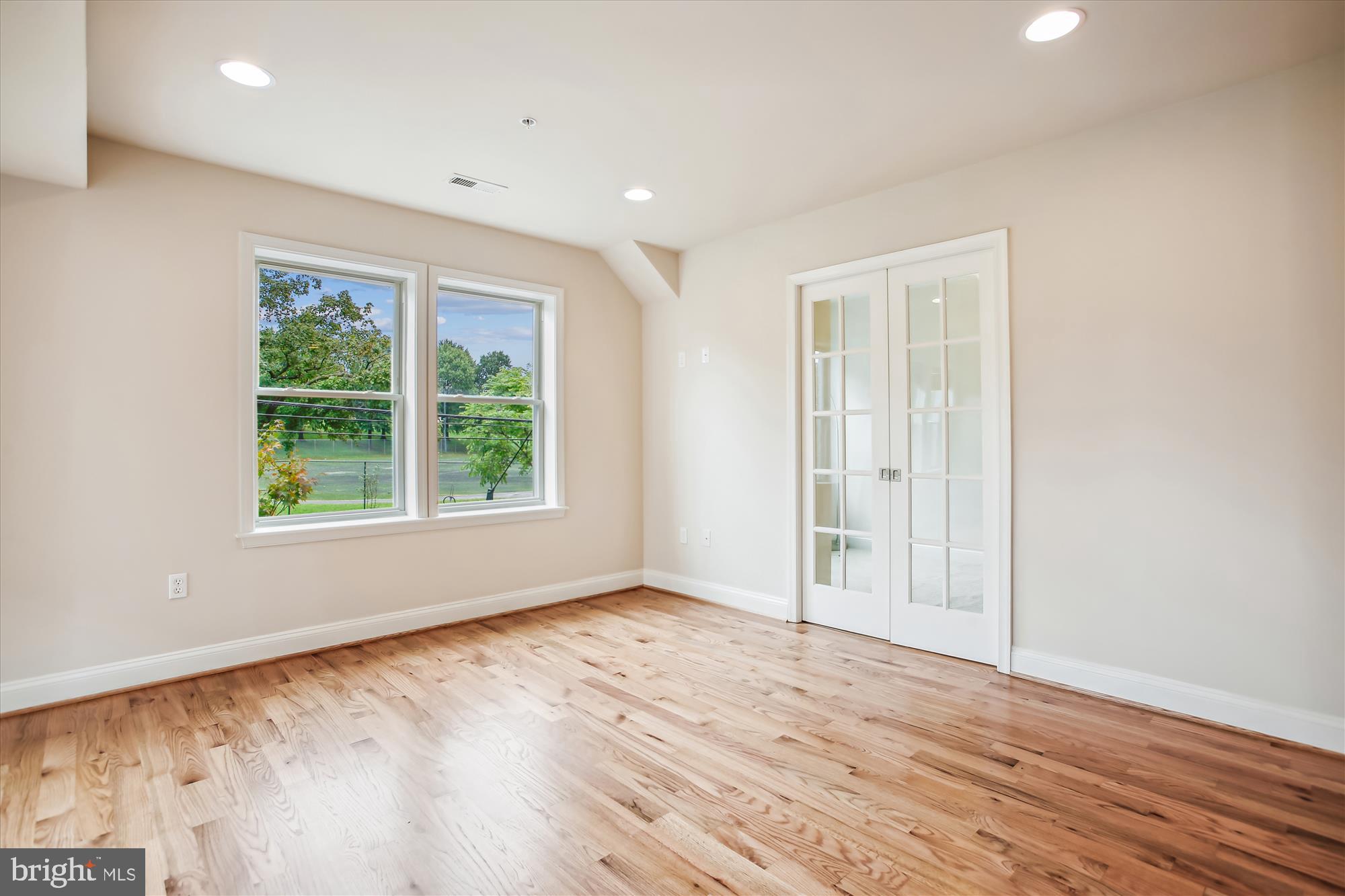 922 Madison Street Northwest, Unit 201 Washington, DC 20011 - Photo 15 of 34 an empty room with wooden floor and windows
