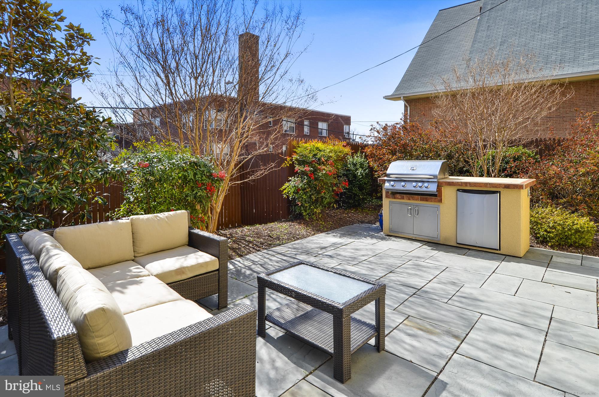922 Madison Street Northwest, Unit 201 Washington, DC 20011 - Photo 27 of 34 a view of a patio with table and chairs with wooden fence and plants