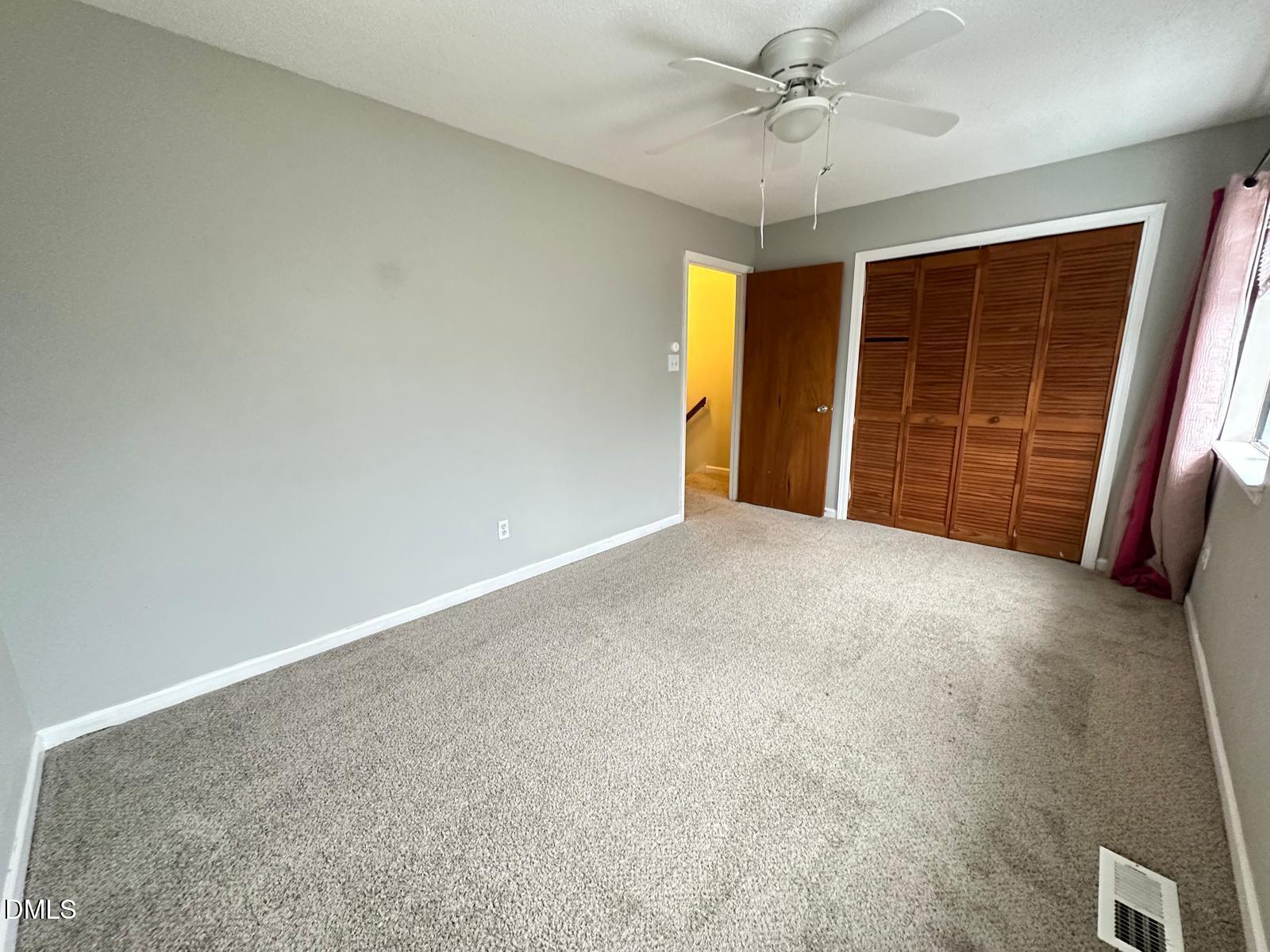 322 Junction Road, Unit 28H Durham, NC 27703 - Photo 15 of 18 an empty room with windows and ceiling fan