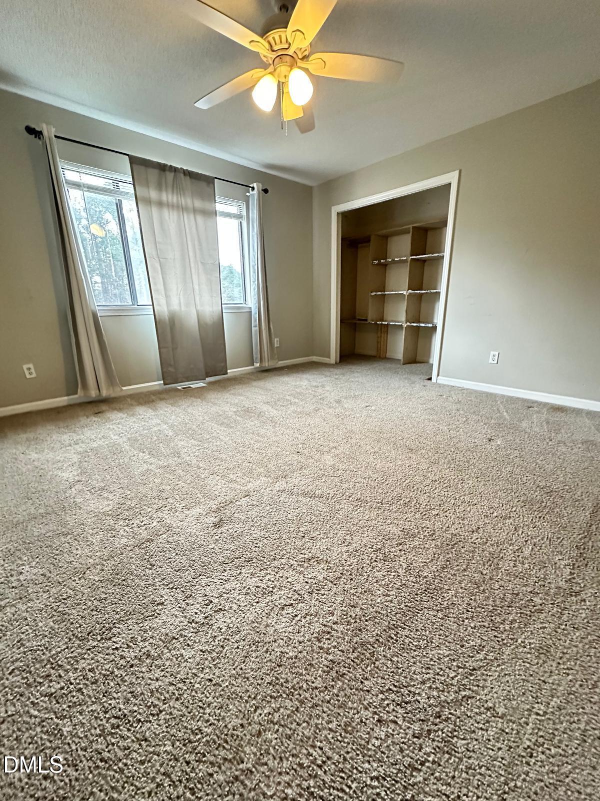 322 Junction Road, Unit 28H Durham, NC 27703 - Photo 16 of 18 an empty room with a empty space and windows
