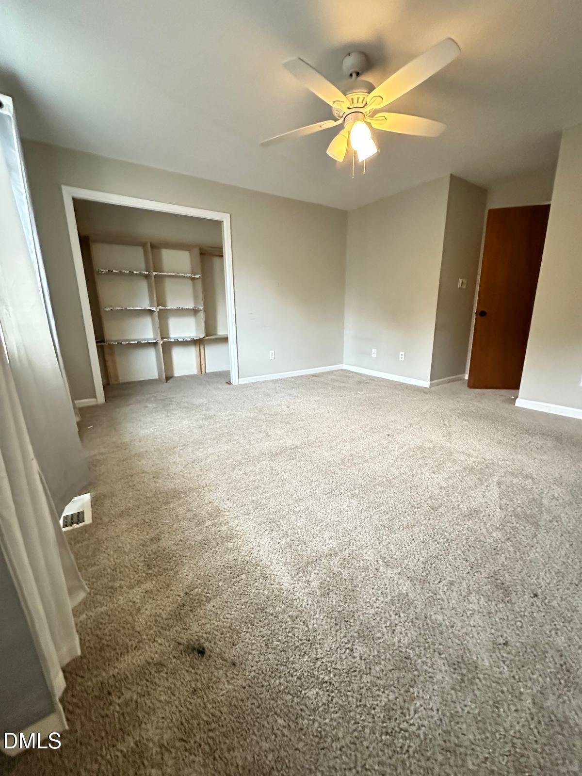 322 Junction Road, Unit 28H Durham, NC 27703 - Photo 17 of 18 an empty room with a window and a ceiling fan