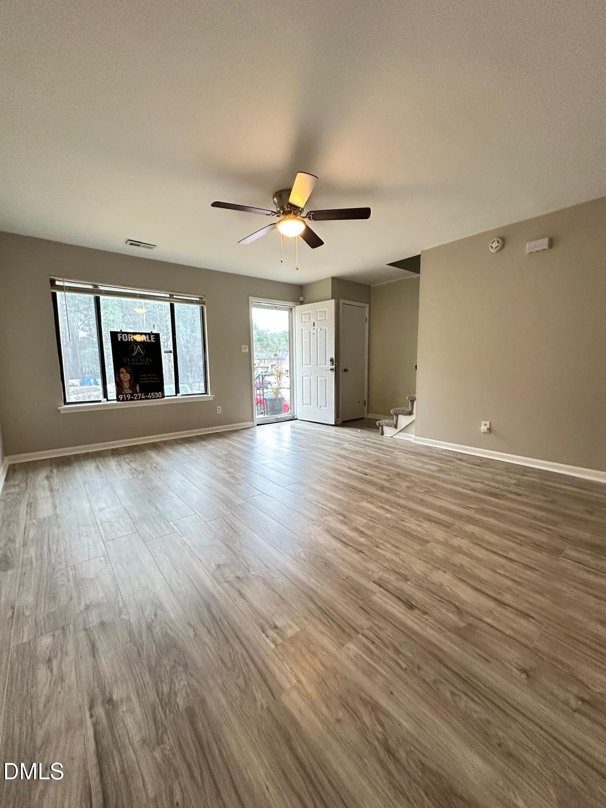 322 Junction Road, Unit 28H Durham, NC 27703 - Photo 5 of 18 a view of an empty room with window and wooden floor