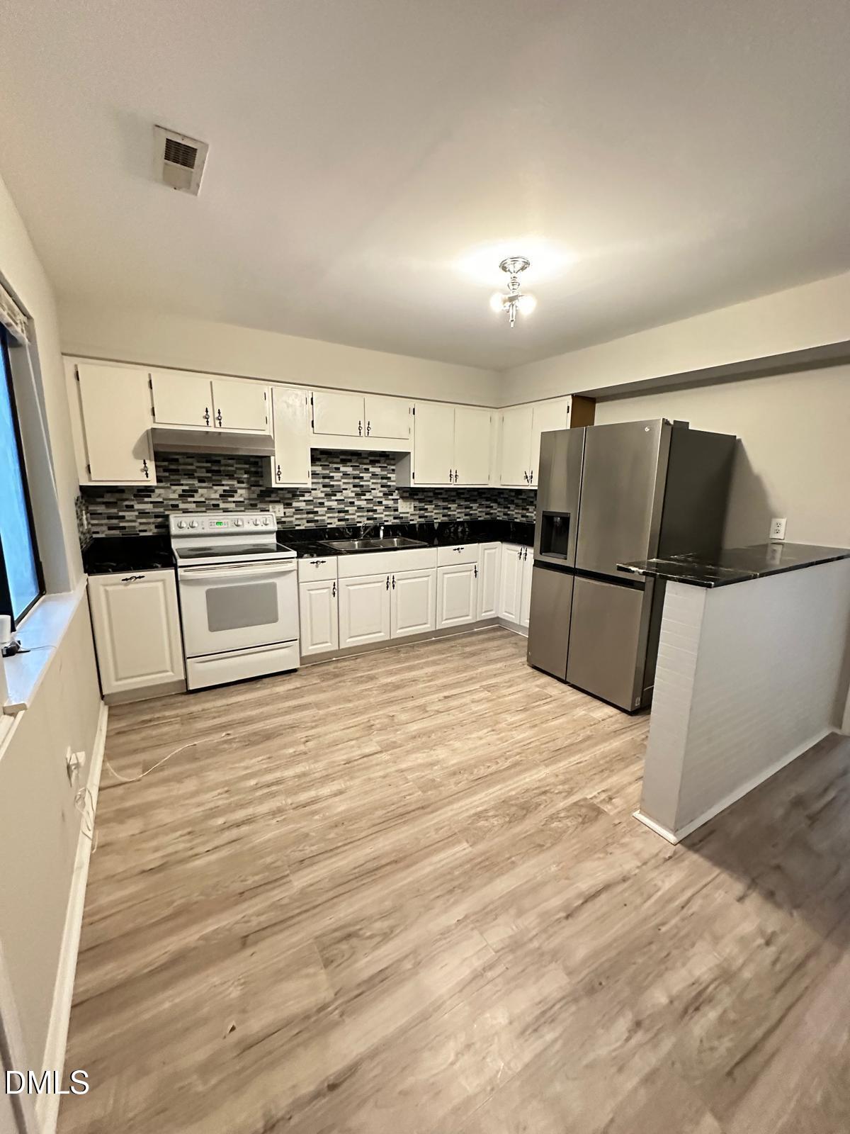 322 Junction Road, Unit 28H Durham, NC 27703 - Photo 7 of 18 a kitchen with stainless steel appliances granite countertop a refrigerator and a stove