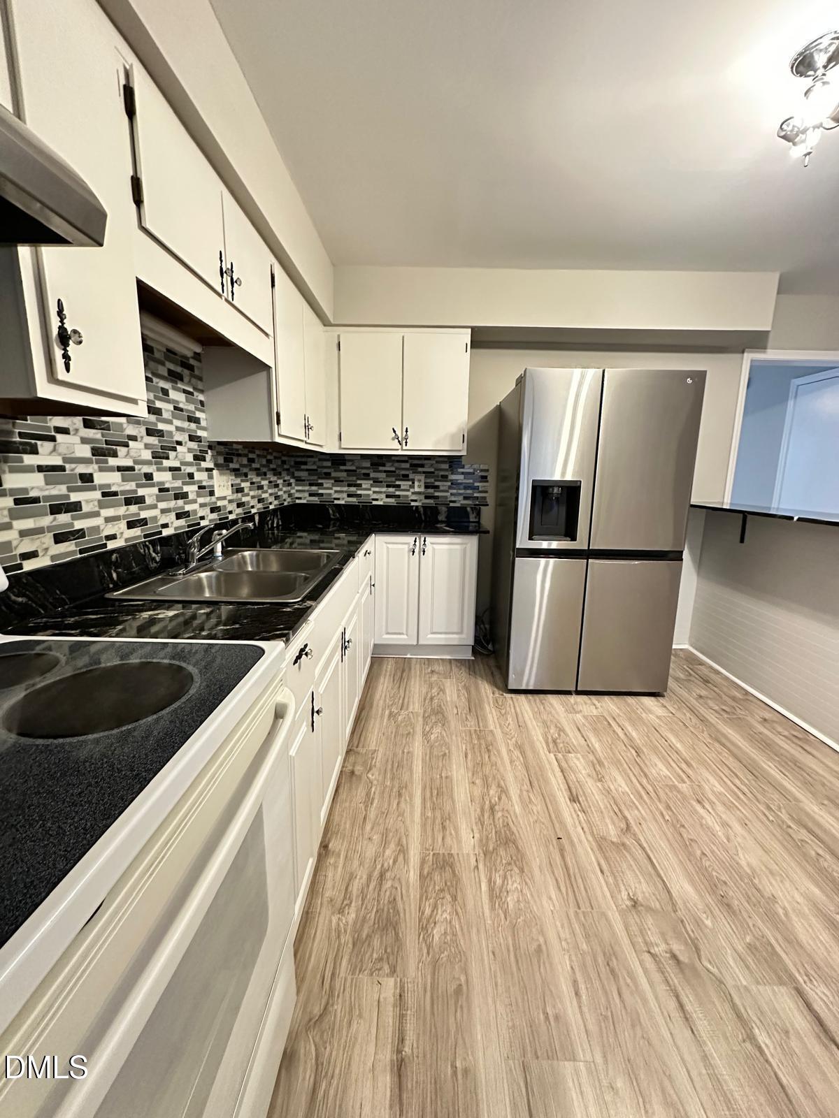 322 Junction Road, Unit 28H Durham, NC 27703 - Photo 8 of 18 a kitchen with stainless steel appliances granite countertop a sink and cabinets