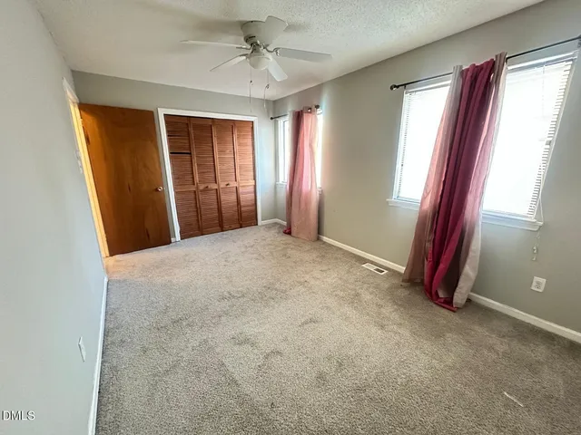 a view of a room with windows and closet