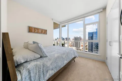 a bedroom with a large bed and a large window