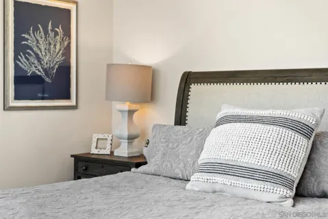 a bedroom with a bed and a painting on the wall