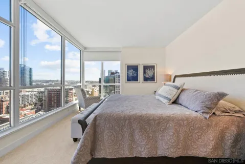 a bed sitting in a bedroom next to a large window