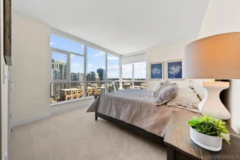 a bed room with a bed and a large window