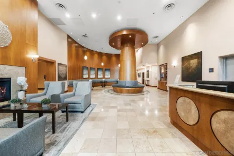 a lobby with furniture and a chandelier