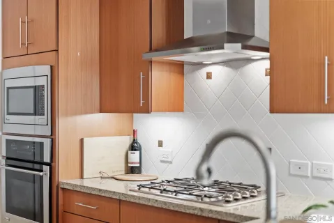 a stove top oven sitting inside of a kitchen