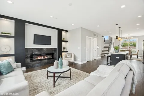a living room with fireplace furniture and a flat screen tv