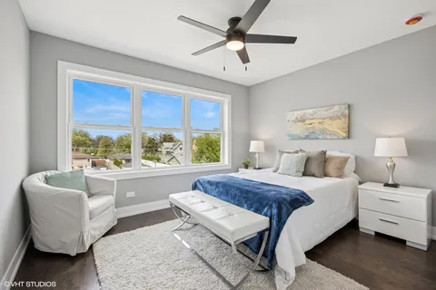 a bedroom with a bed and a large window