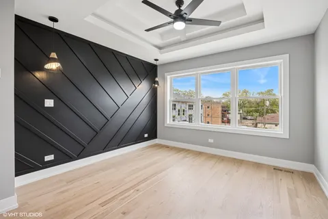 a view of a livingroom with a ceiling fan and window