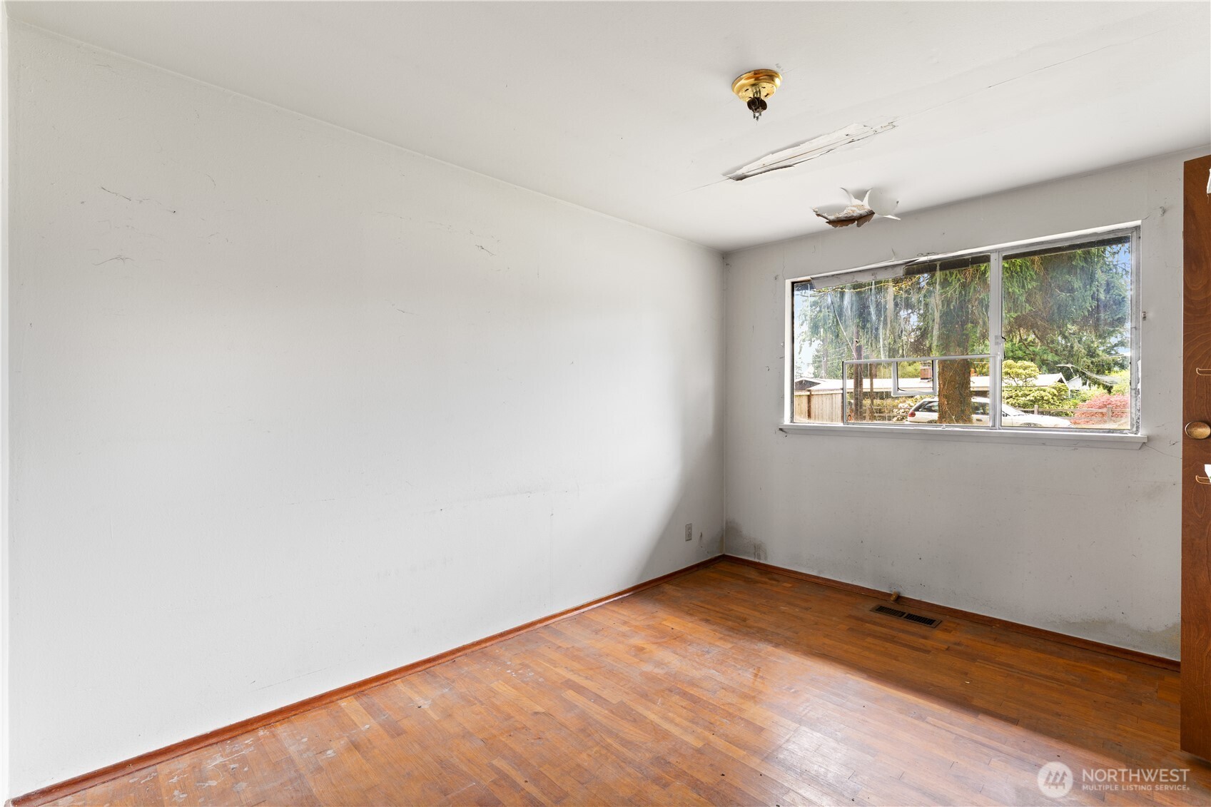 9012 Northeast 178th Street Bothell, WA 98011 - Photo 22 of 30 an empty room with wooden floor and windows