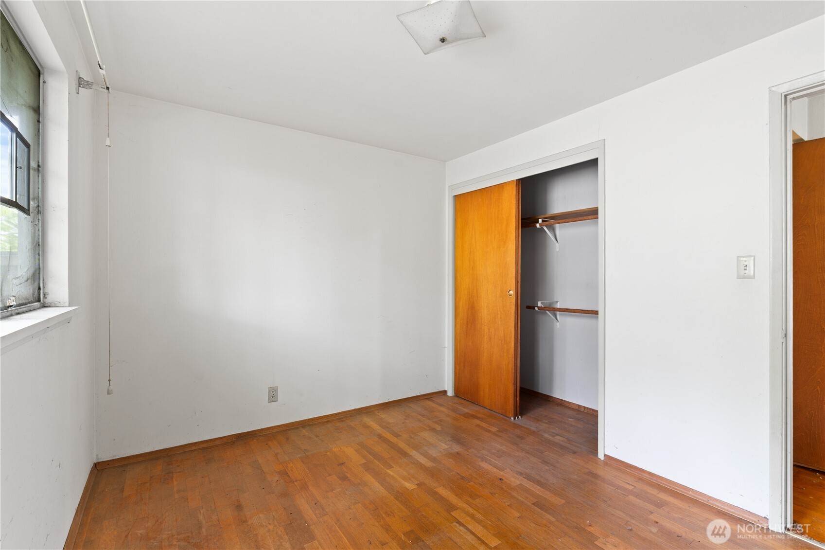 9012 Northeast 178th Street Bothell, WA 98011 - Photo 27 of 30 a view of an empty room with wooden floor and a window