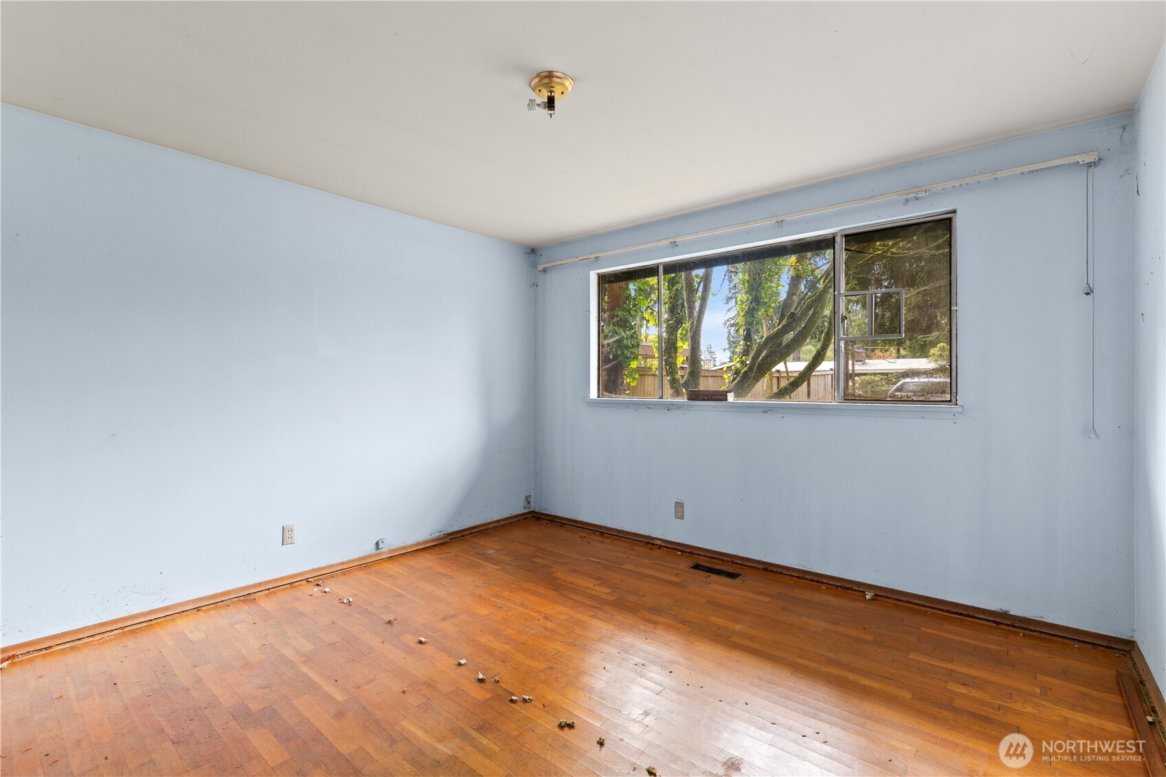 9012 Northeast 178th Street Bothell, WA 98011 - Photo 28 of 30 a view of an empty room with wooden floor and a window