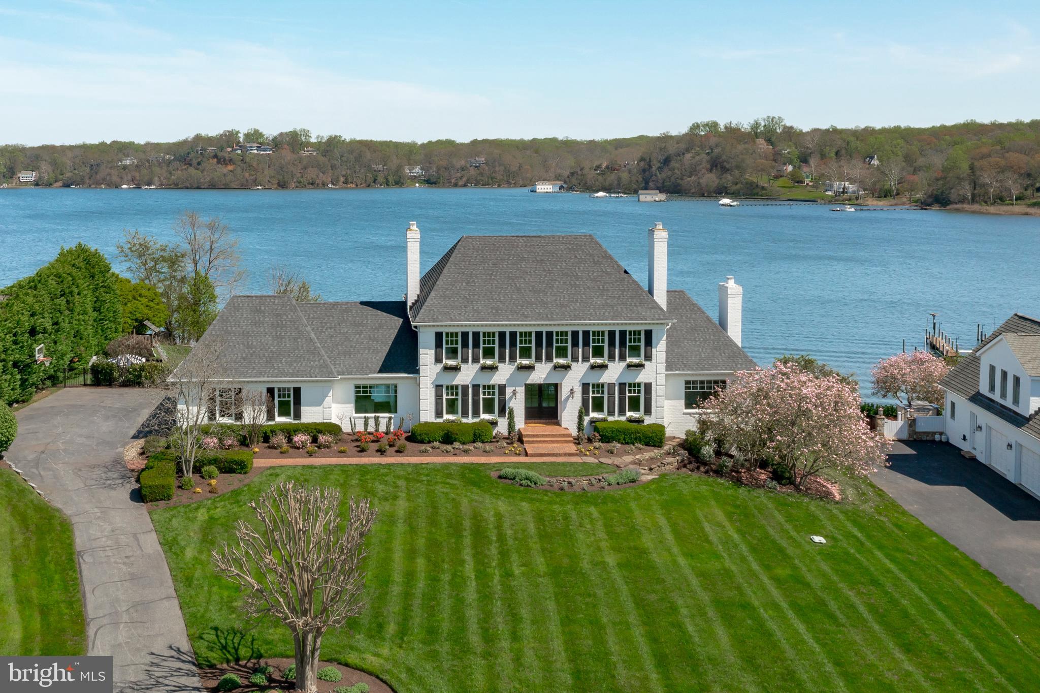 a aerial view of a house with a garden and lake view