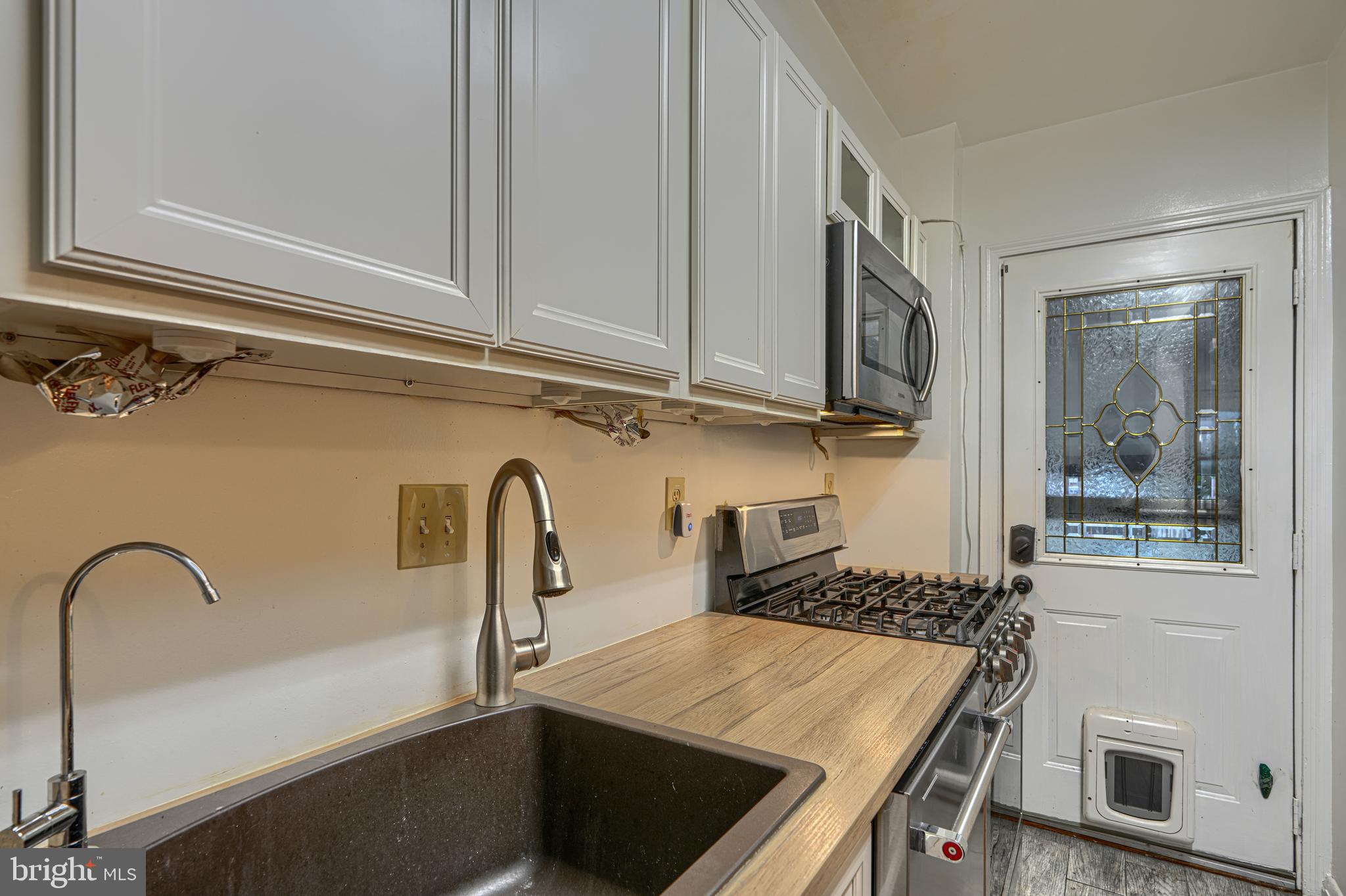 308 Imla Street Baltimore, MD 21224 - Photo 7 of 22 Work area in 1st floor kitchen leads to rear porch