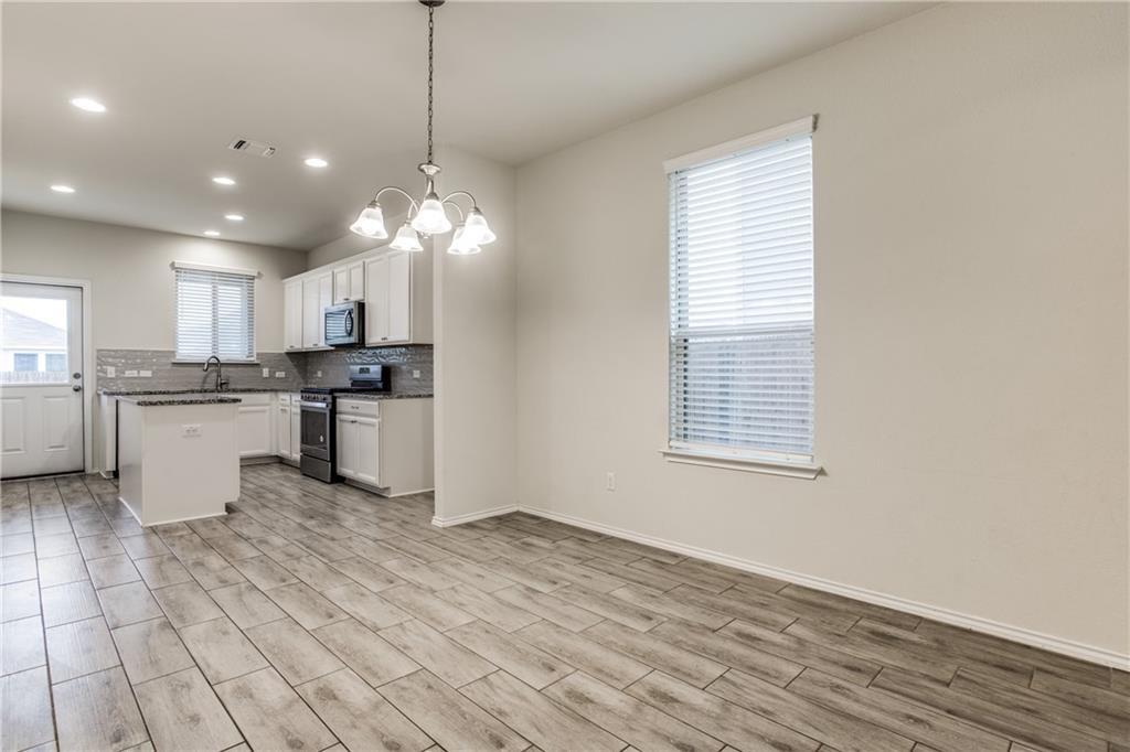 1413 Cliffbrake Way Georgetown, TX 78626 - Photo 8 of 30 a kitchen with stainless steel appliances granite countertop a stove top oven a sink dishwasher and a refrigerator