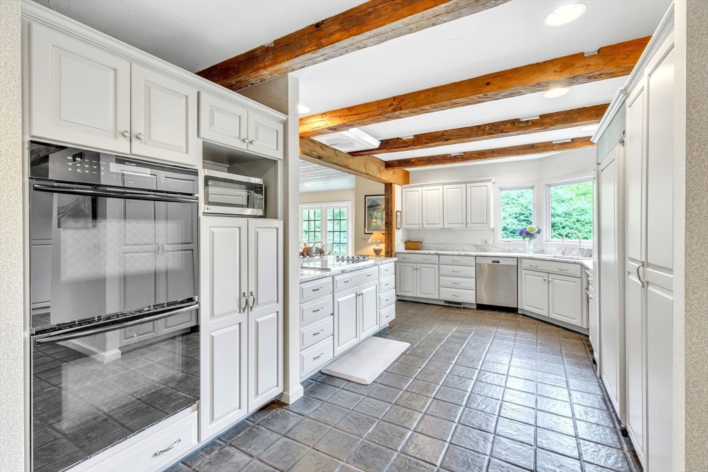 147 Shaker Road Longmeadow, MA 01106 - Photo 12 of 42 a kitchen with a refrigerator a sink and cabinets