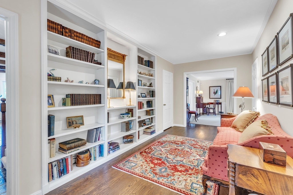 147 Shaker Road Longmeadow, MA 01106 - Photo 3 of 42 a living room with hard wood flooring and a book shelf