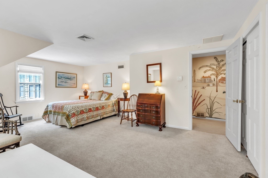 147 Shaker Road Longmeadow, MA 01106 - Photo 31 of 42 a spacious bedroom with a bed and a table