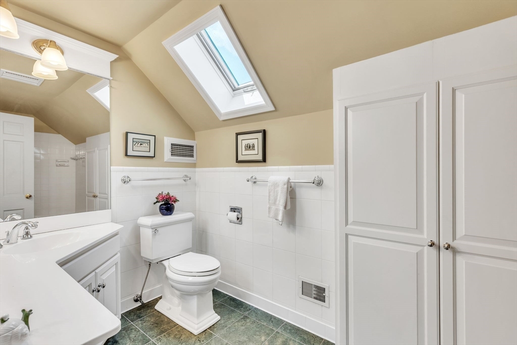 147 Shaker Road Longmeadow, MA 01106 - Photo 35 of 42 a bathroom with a toilet sink vanity and mirror