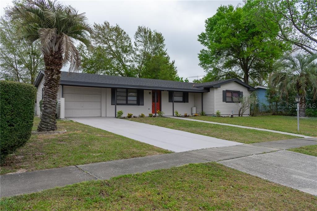 3565 Southwest 147 Lane Road Ocala, FL 34473 - Photo 1 of 1 a front view of a house with a garden
