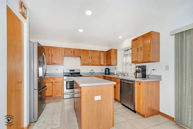 a kitchen with stainless steel appliances granite countertop a stove top oven a sink a counter top space and cabinets