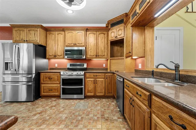 a kitchen with stainless steel appliances granite countertop a stove and a refrigerator