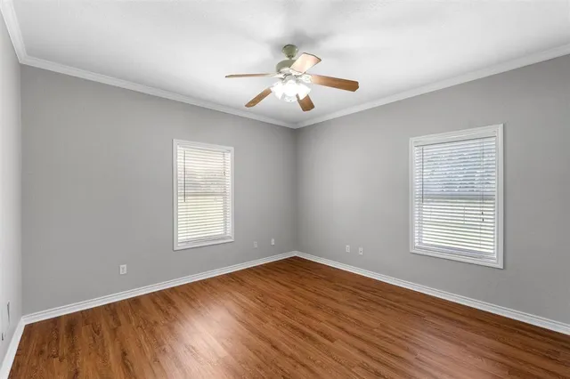 wooden floor in an empty room with a window