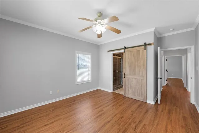 a view of a livingroom with a ceiling fan window and wooden floor