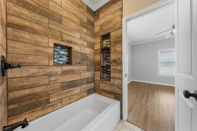 a bathroom with a bathtub and shower