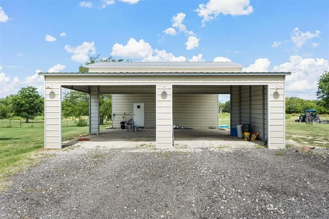 a view of a house with a yard and garage