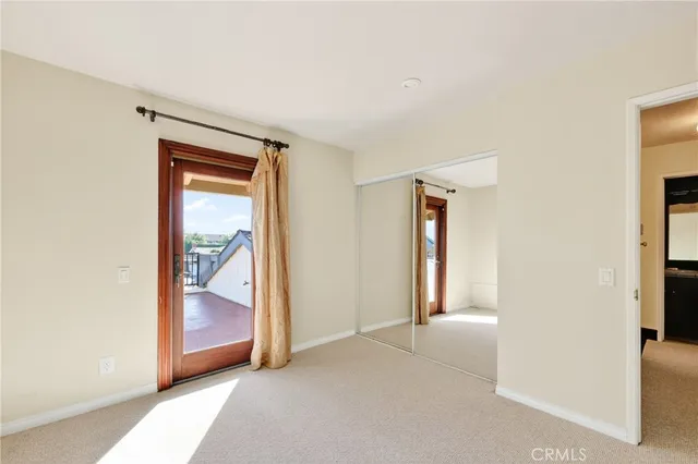an empty room with glass door and shower