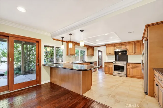 a kitchen with stainless steel appliances granite countertop a stove and cabinets
