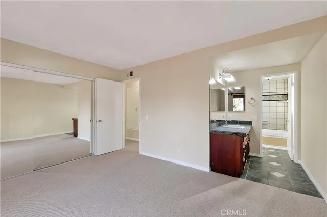 a view of kitchen with granite countertop cabinets and refrigerator