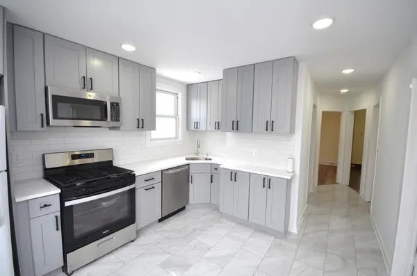 a kitchen with a sink and steel appliances