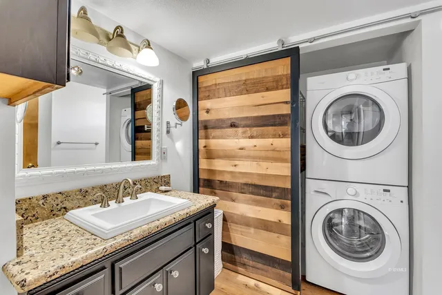 a bedroom with a bed and large windows