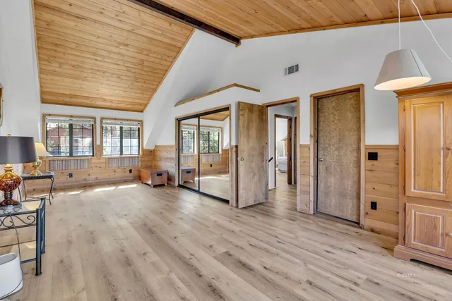 a view of a balcony with wooden floor and fence