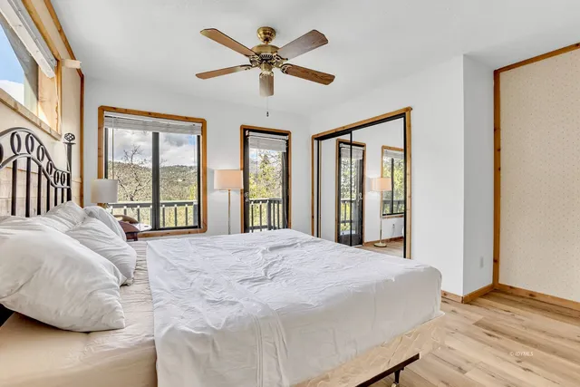 a view of a patio with couches table and chairs and wooden floor