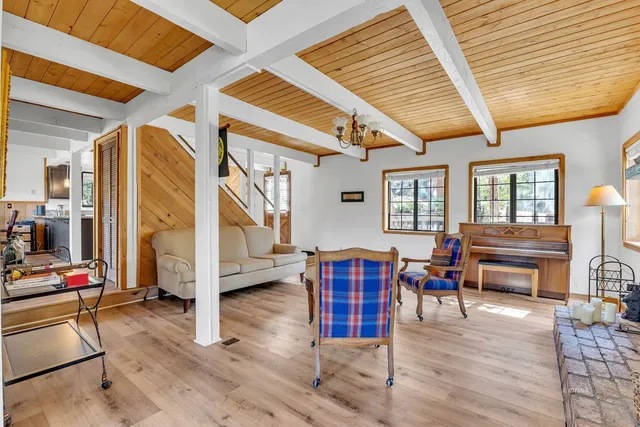 a view of a room with wooden floor and windows
