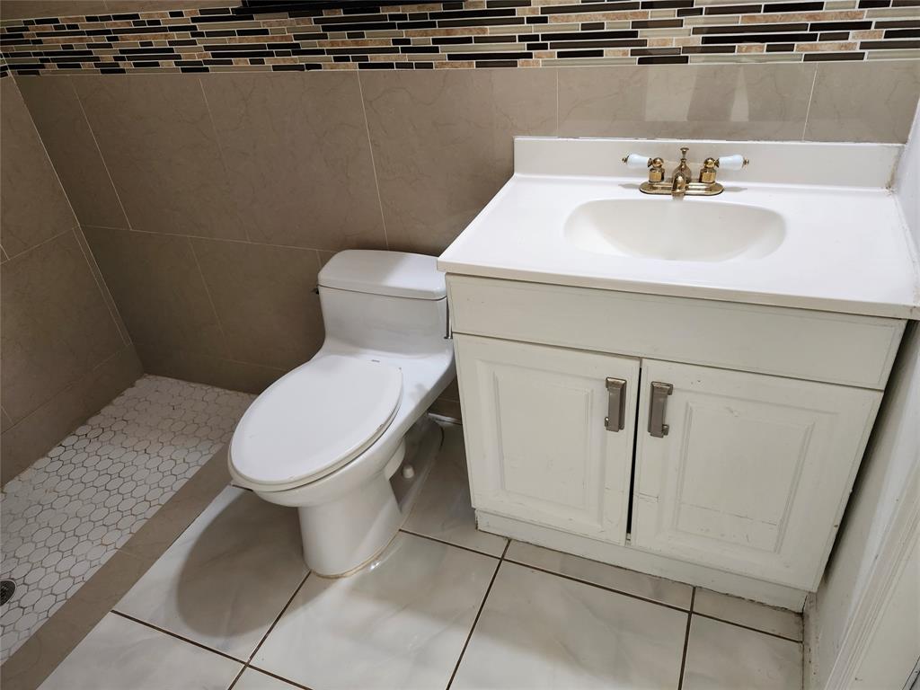 10720 Eureka Street Boca Raton, FL 33428 - Photo 11 of 18 a white toilet sitting next to a bathroom sink