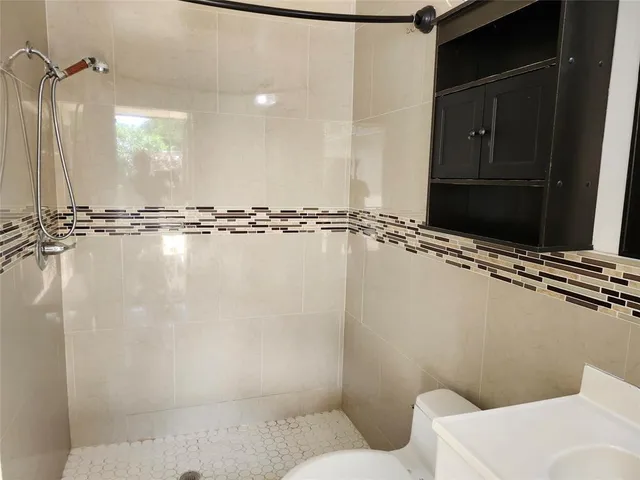 a bathroom with a sink toilet and shower