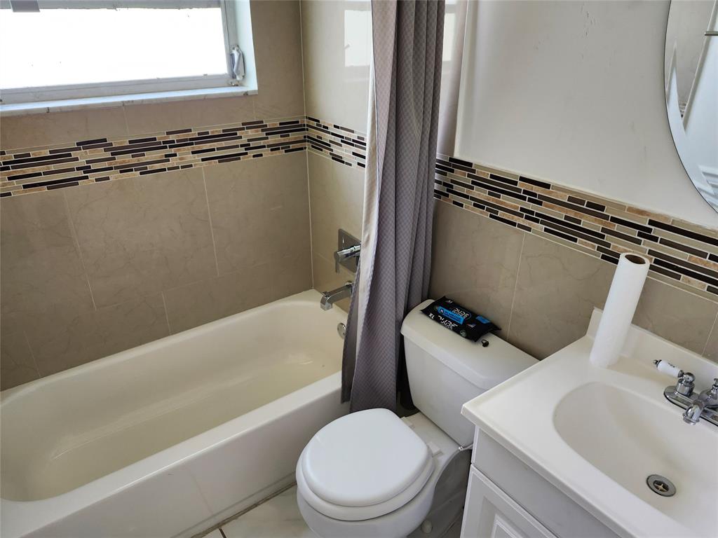 10720 Eureka Street Boca Raton, FL 33428 - Photo 13 of 18 a bathroom with a sink toilet and shower