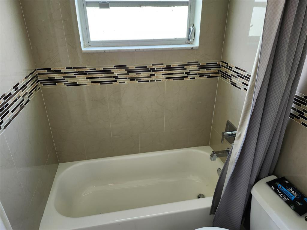 10720 Eureka Street Boca Raton, FL 33428 - Photo 14 of 18 a bathroom with a tub a window and a shower