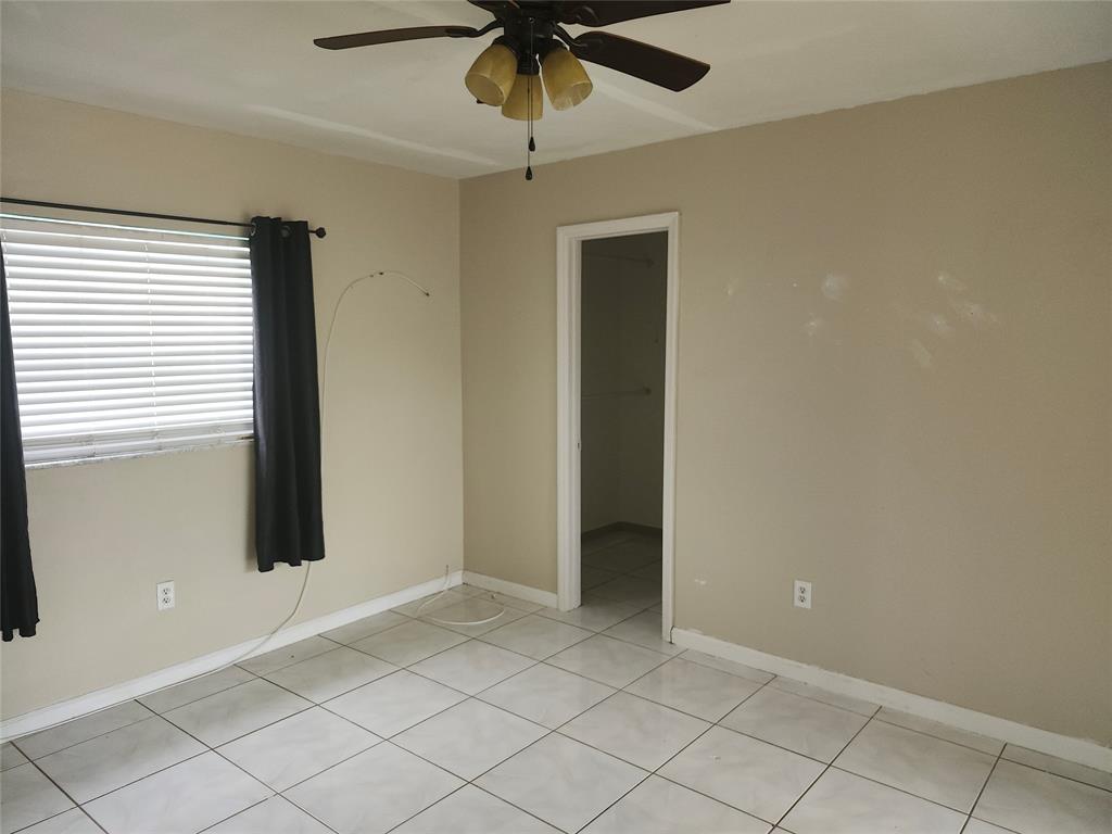 10720 Eureka Street Boca Raton, FL 33428 - Photo 15 of 18 an empty room with a ceiling fan and window