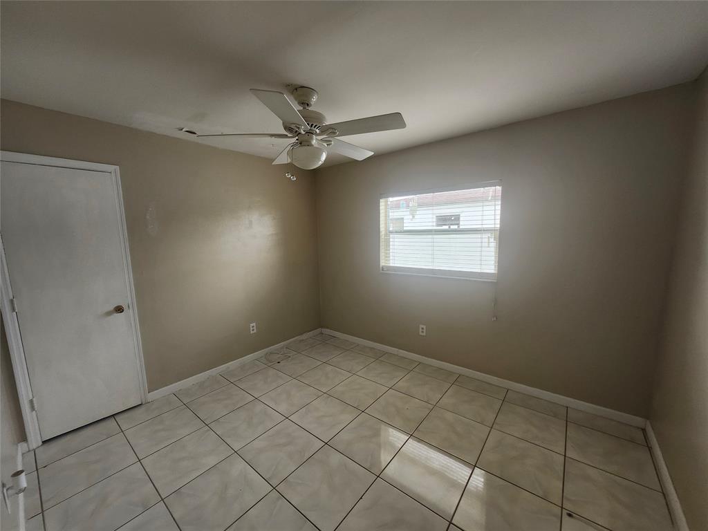 10720 Eureka Street Boca Raton, FL 33428 - Photo 17 of 18 an empty room with windows and fan