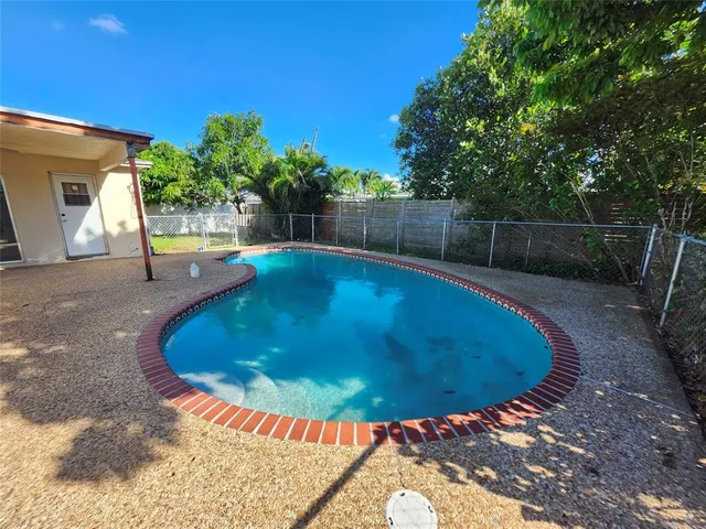 a swimming pool with outdoor seating